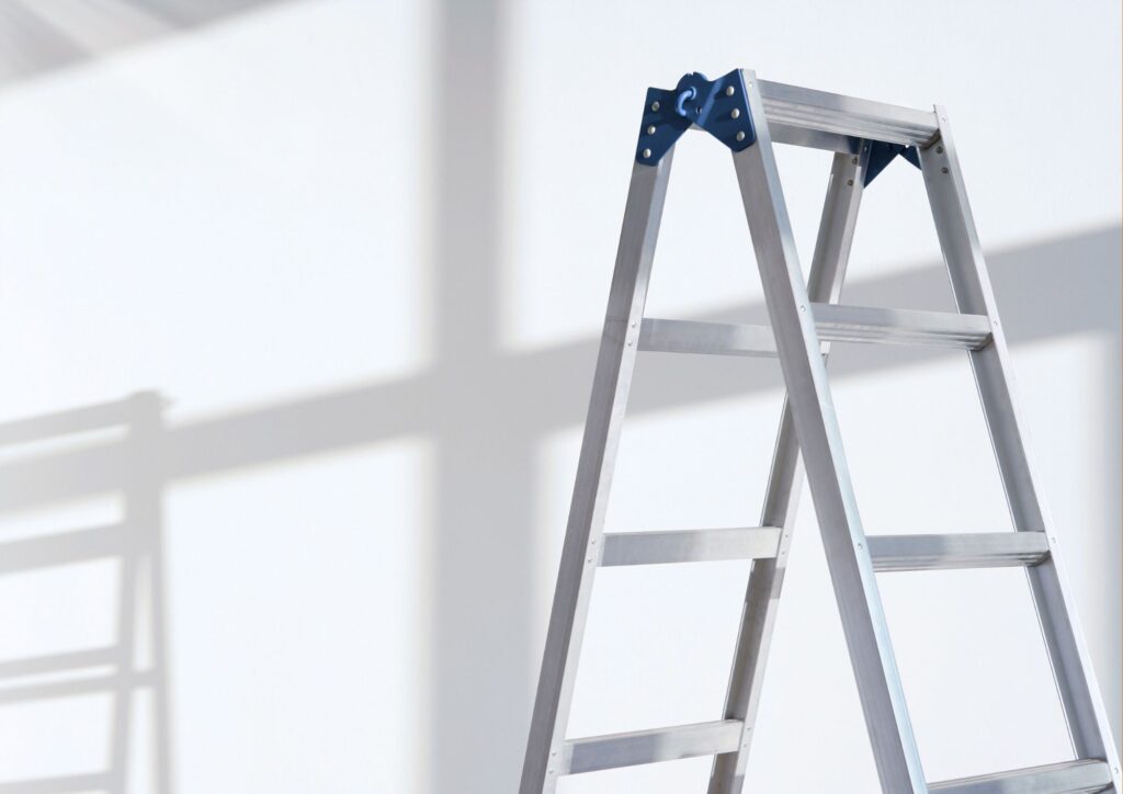 Light-duty articulating ladder used carefully on residential stairs