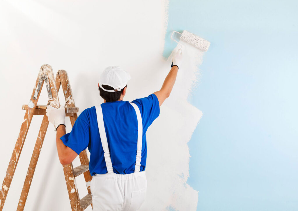 Exterior house painting safety practices including ladder stabilization and fall prevention