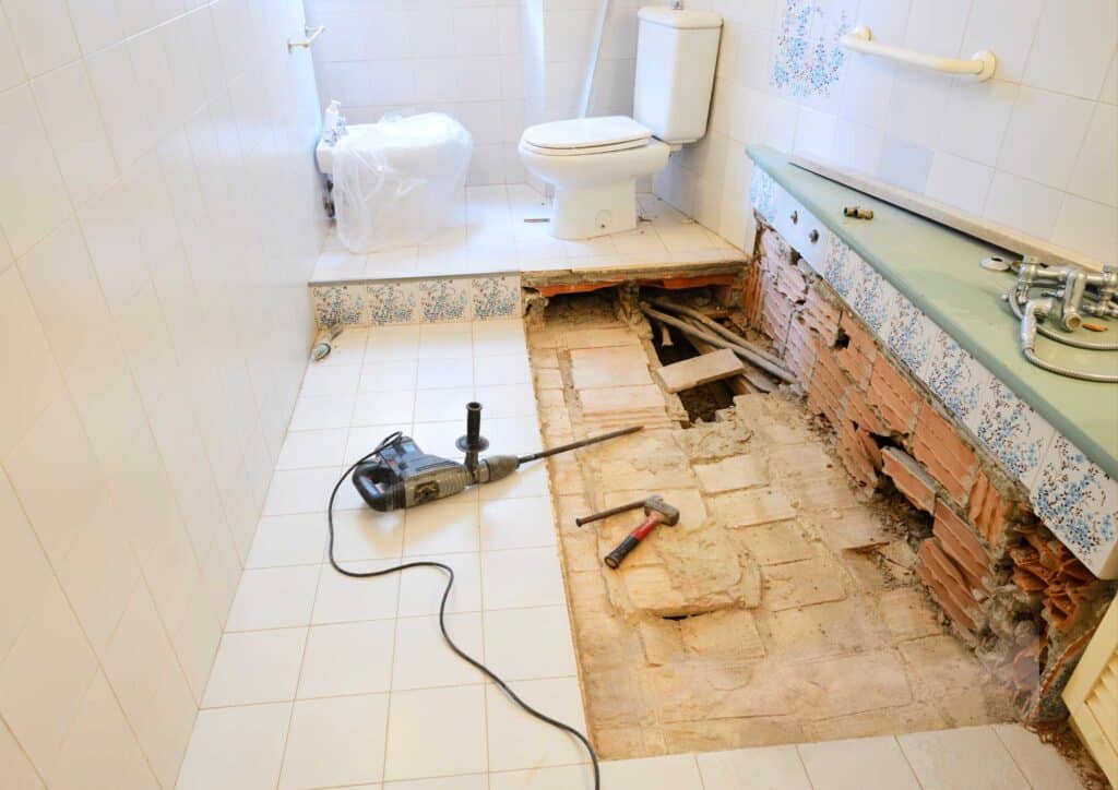 Gut remodel showing walls opened to framing with electrical and plumbing exposed