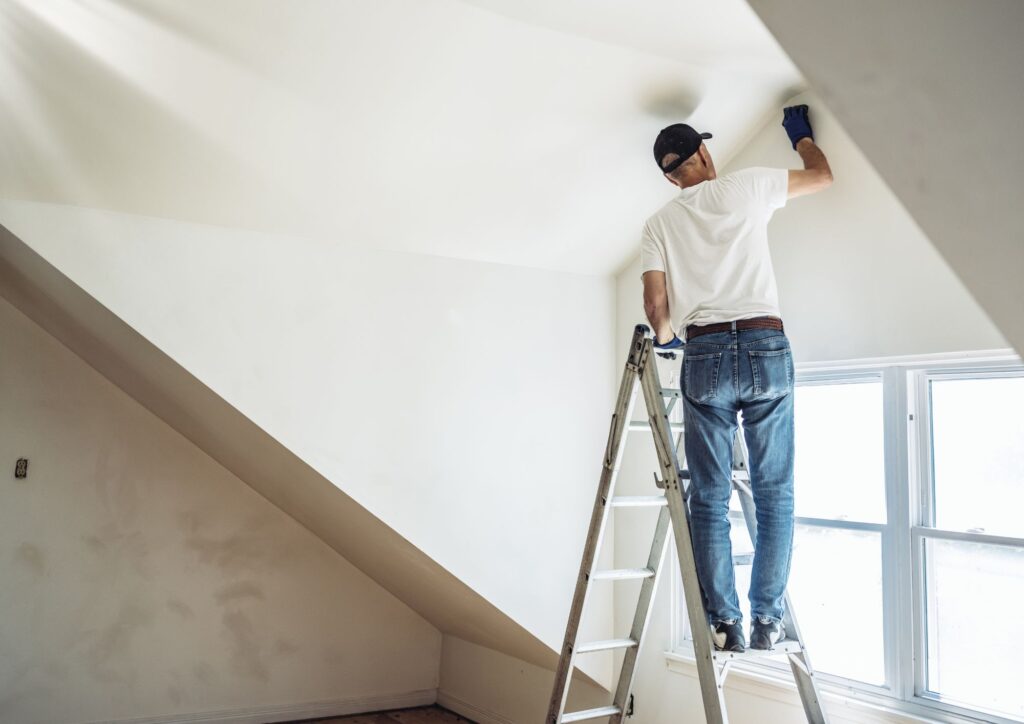Articulating ladder safely positioned on stairs for high ceiling home maintenance