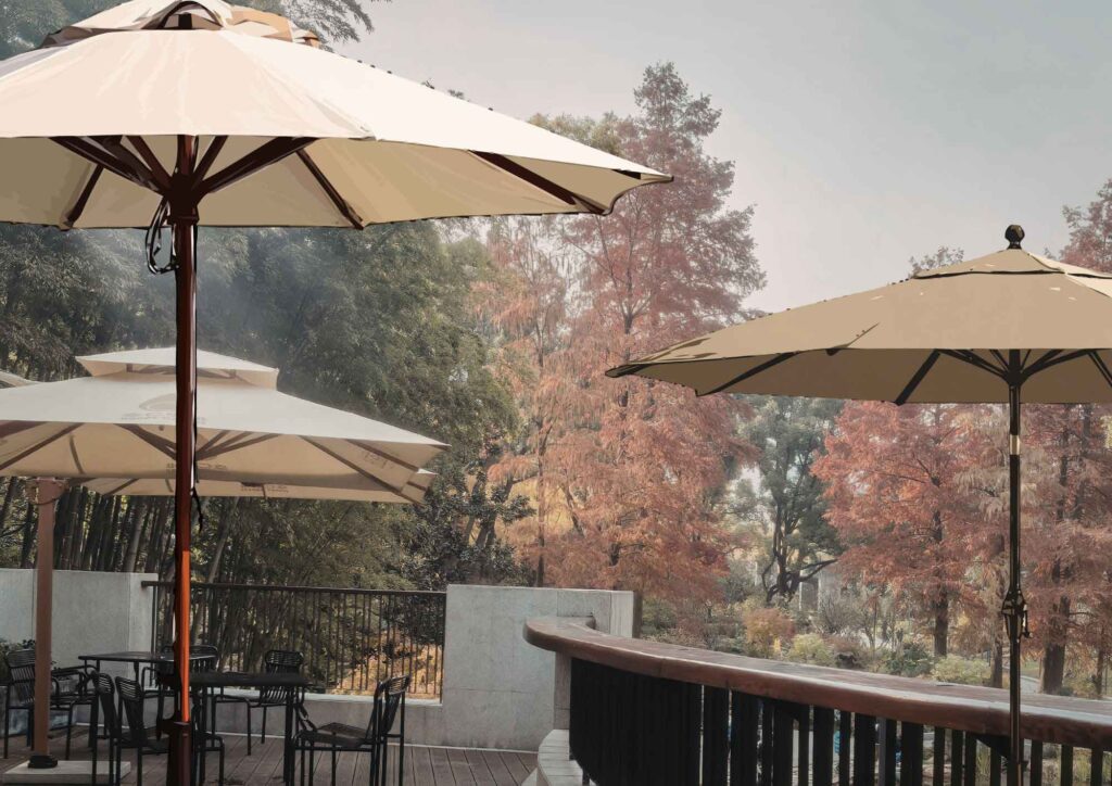 Comparison of different large patio umbrellas with stands in outdoor settings.
