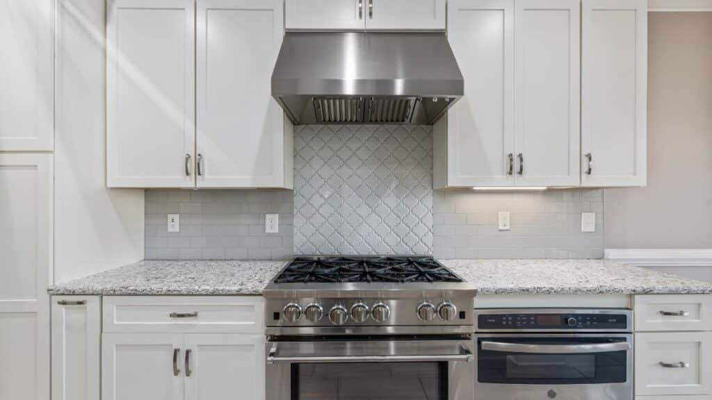 30-inch gas stove with 900 CFM ducted wall-mount range hood venting steam outdoors