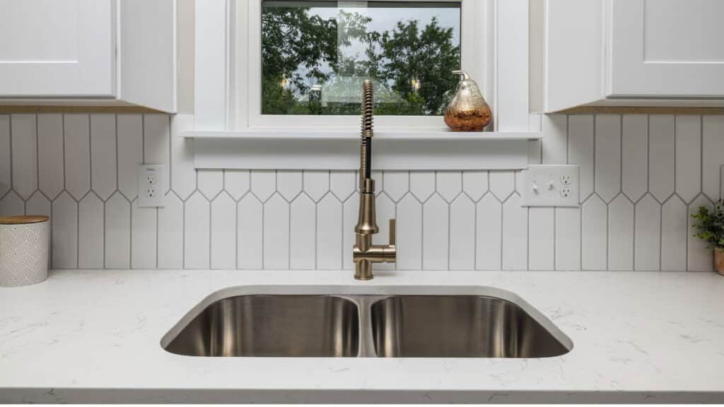 33 inch stainless steel double bowl drop in kitchen sink installed in a modern kitchen