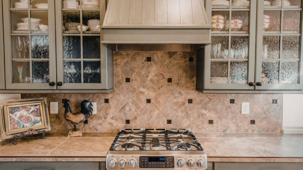 Under cabinet vent hood installed above a 30-inch gas range with visible steam capture