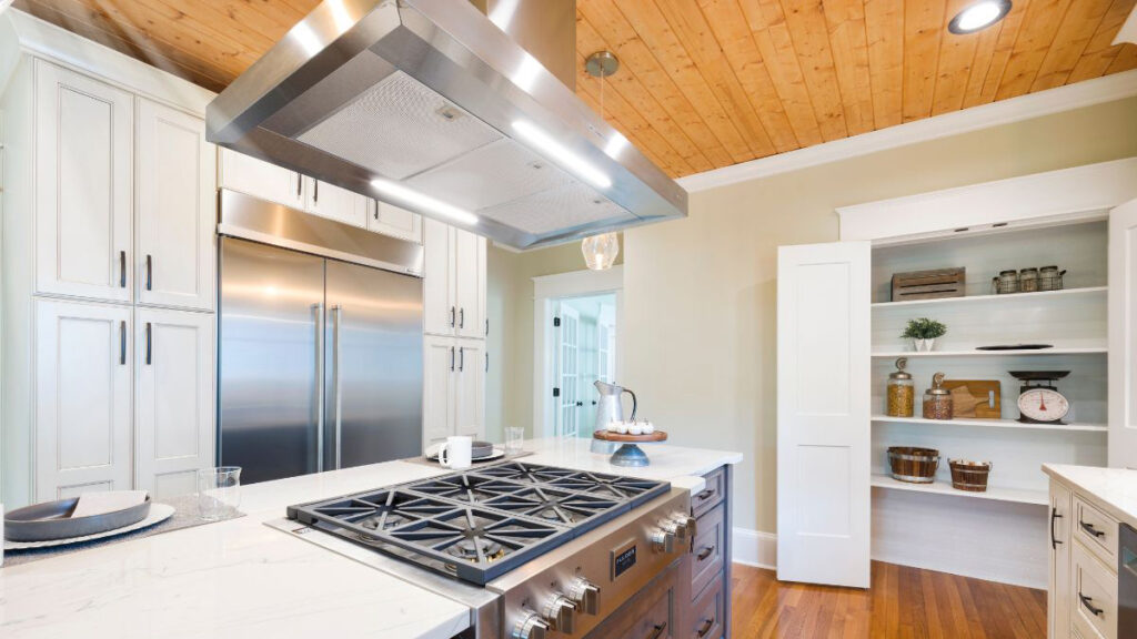 Ceiling mounted kitchen extractor fan installed above an island gas range