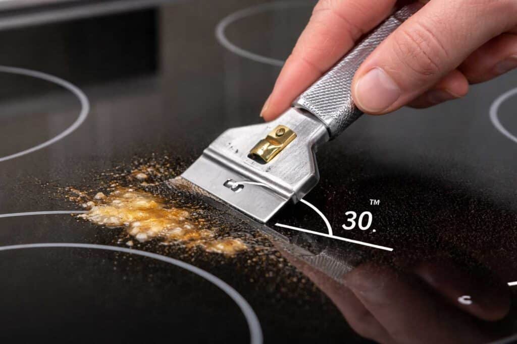 Proper shallow angle technique using scraper on glass cooktop