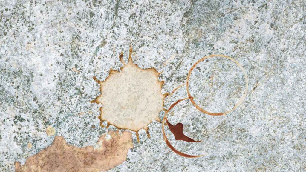 Grease buildup on granite countertop near kitchen cooktop