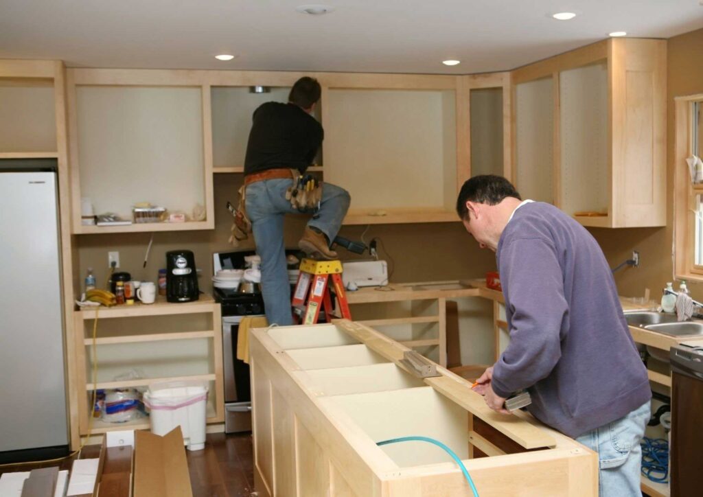 Installing base cabinets for kitchen island.