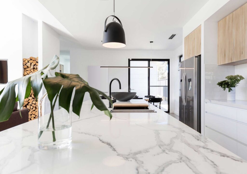 Modern kitchen island with built-in sink and cooktop.