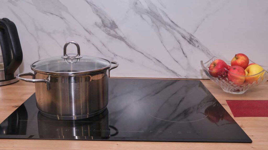 Protective cooking pad for glass top stove on clean surface