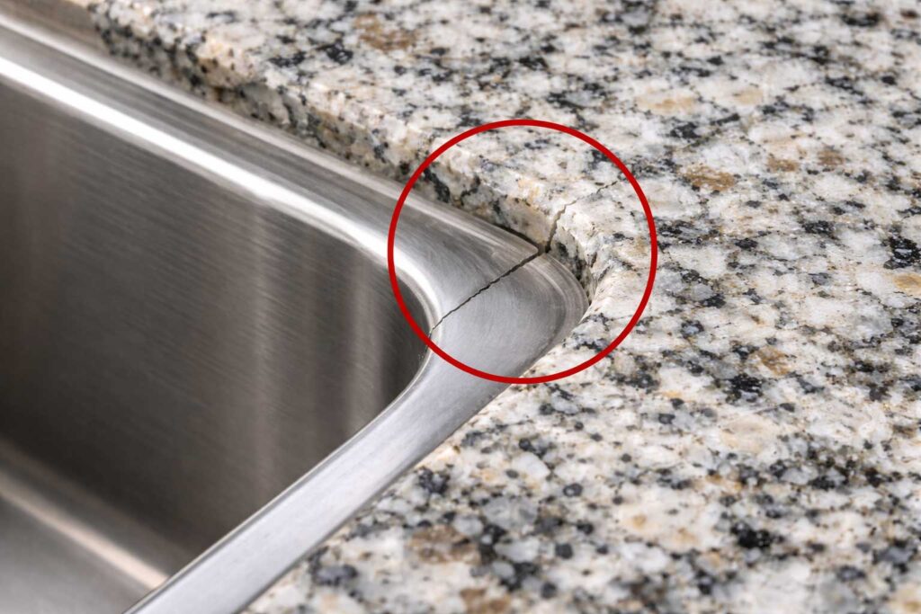 Hairline crack in quartz countertop near sink cutout