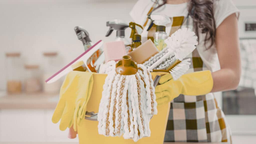 Microfiber cloth, baking soda, dish soap, and soft brush for cleaning stove hood