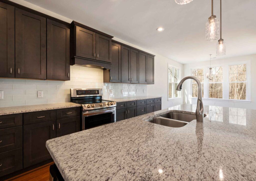 Traditional kitchen with granite countertop island and seating.