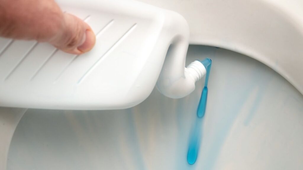 applying toilet bowl cleaner under rim for hard water stains