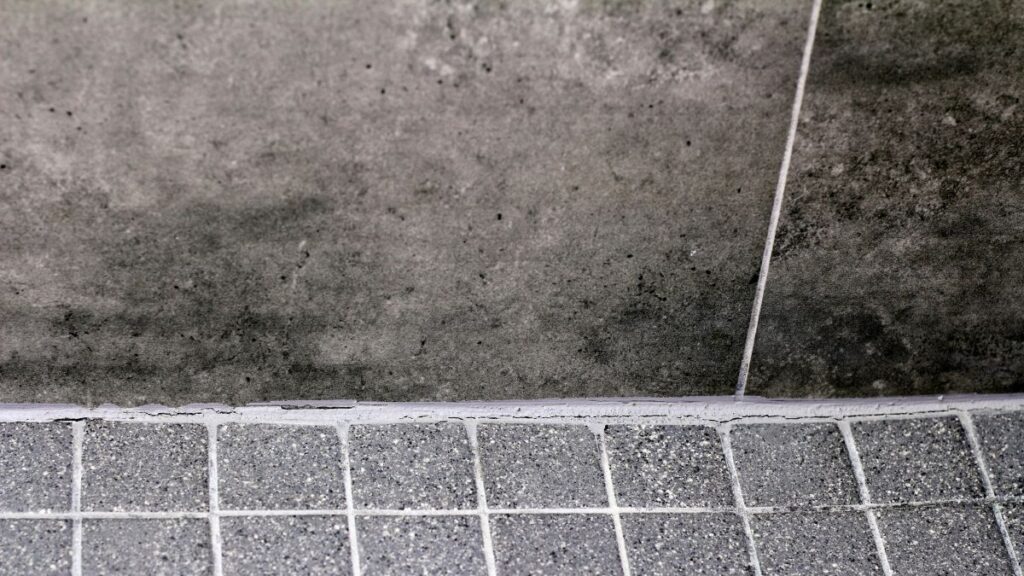 cracked grout and failing caulk in shower requiring repair