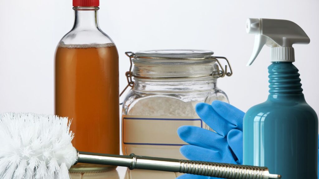 Shower cleaning supplies including vinegar baking soda sponge and spray bottle